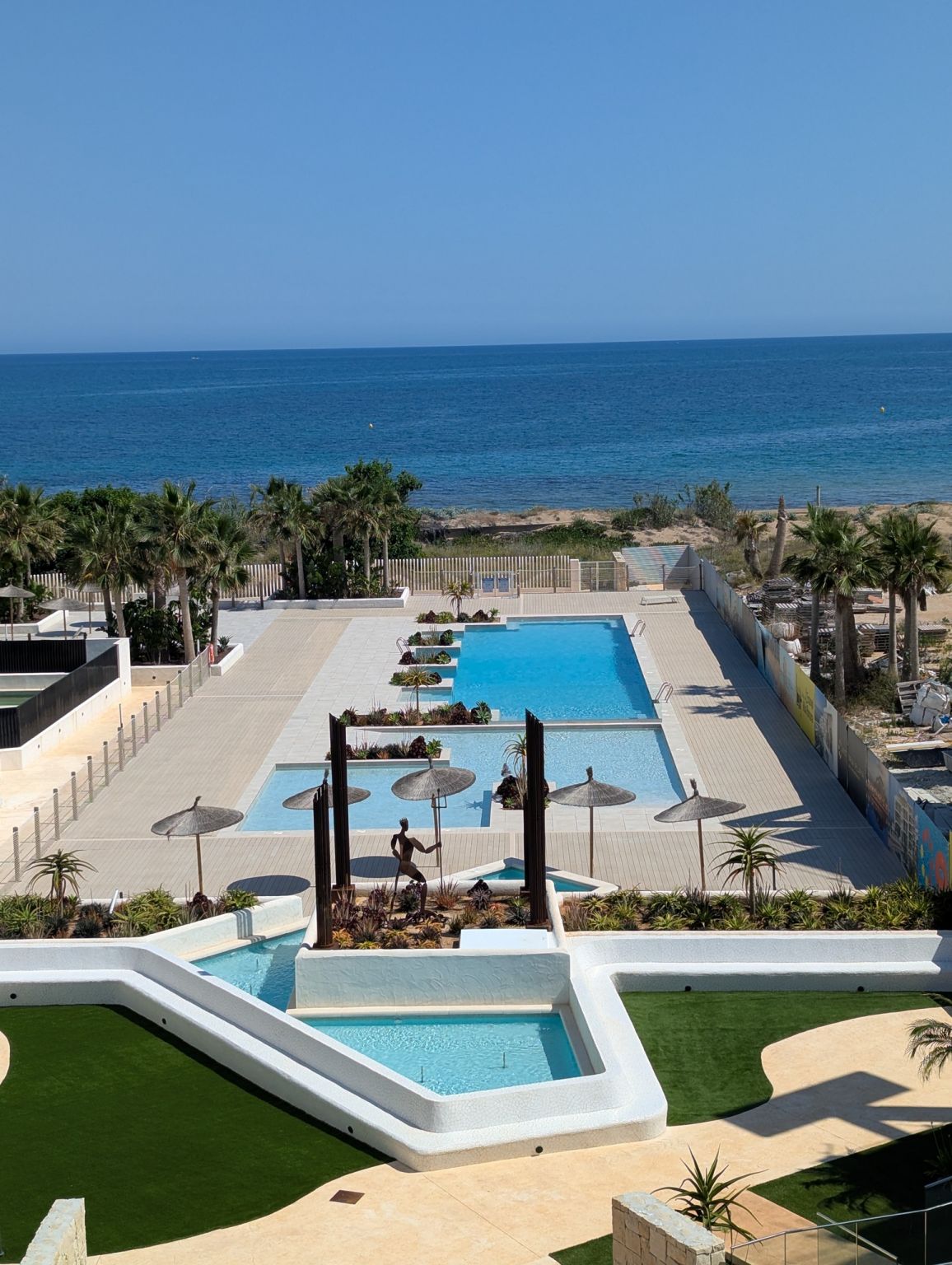 Outdoor seating area near communal pool, new-build development, Denia