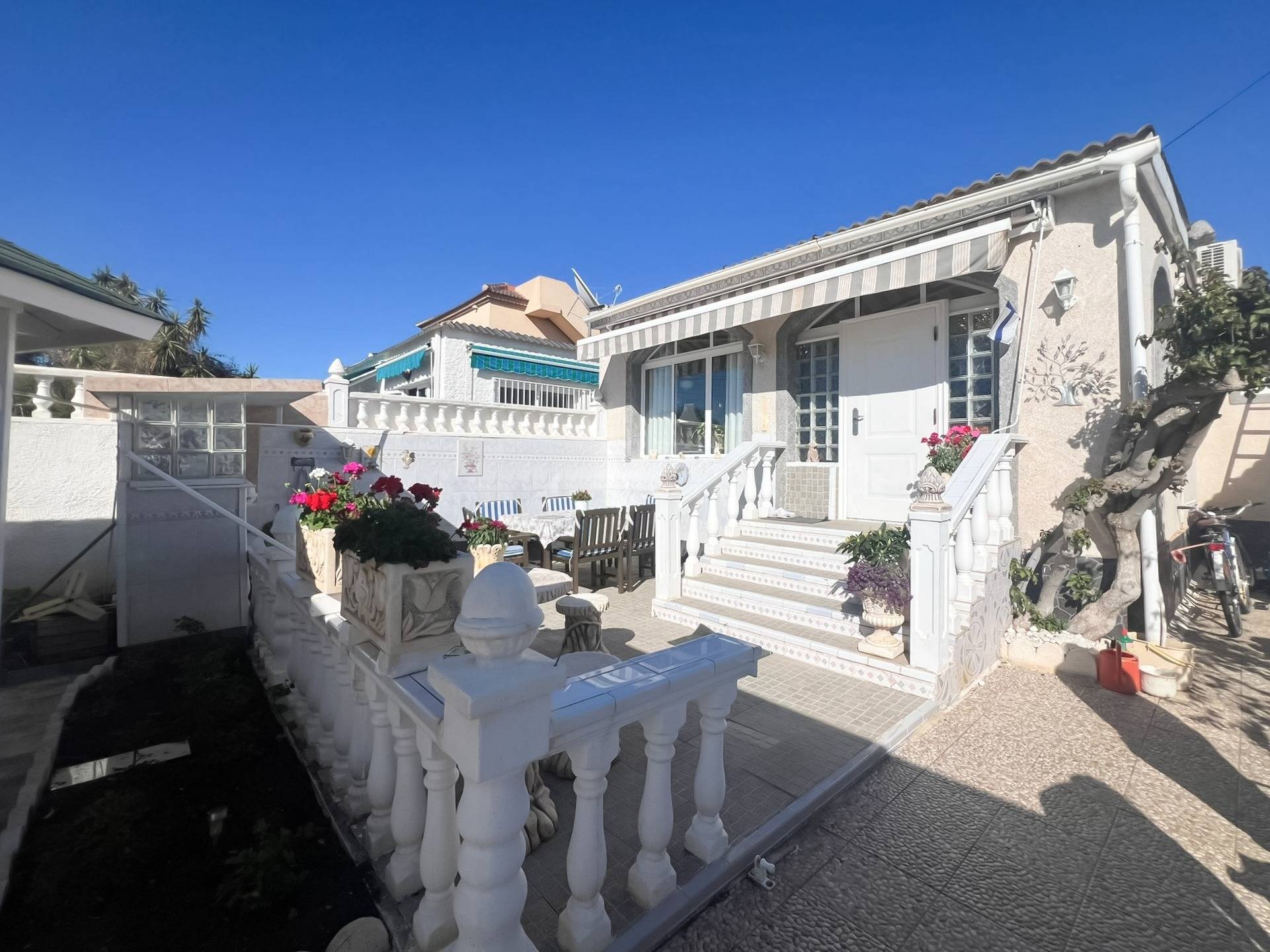 Front entrance and rendered facade of 3-bedroom villa in La Siesta, Torrevieja